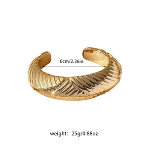 Detailed view of gold plated spiral textured cuff bracelet with 6cm inner diameter