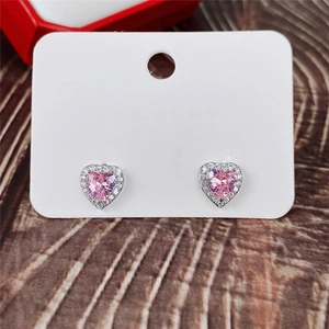 Detail of pink heart-shaped cubic zirconia studs with silver base on jewelry card