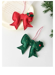 Detail of felt Christmas bow pendant with golden polka dots and festive holly leaf decor