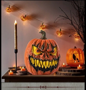 Close-up of spooky monster pumpkin with sharp yellow teeth and realistic resin texture