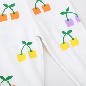 Girl's stretch knit leggings with colorful cherry embroidery on soft white cotton fabric
