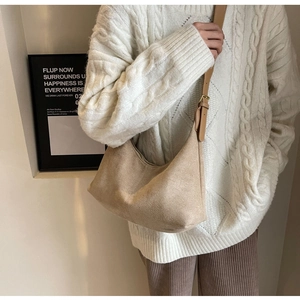 Detail of khaki frosted faux suede tote bag with leather strap on model crossbody