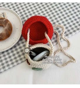 Detail view of handmade crochet mini bucket bag holding daily essentials like lipstick