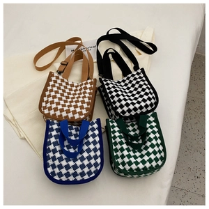 Top view of four woven plaid canvas bags in brown, black, blue, and green patterns