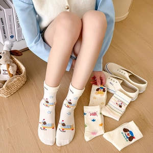 Chic cream crew socks featuring cartoon dachshund patterns and knitted puppy illustrations