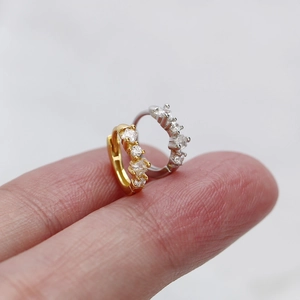 Close-up of minimalist 925 silver hoop earrings with five tiny sparkling zircon stones