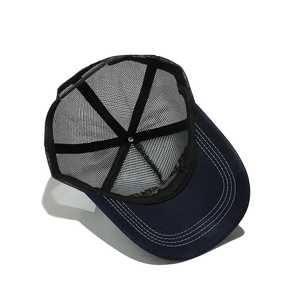Internal view of navy trucker hat showing mesh panels and adjustable snapback closure