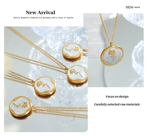 Macro shot of French vintage gold rose pendant with white enamel and relief detail