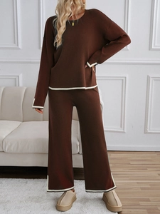 Detailed texture of dark brown knit lounge set featuring white stripe cuffs and wide-leg pants