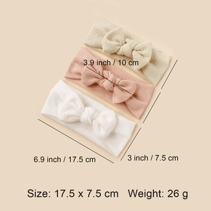 Three-pack elastic baby headbands with textured bows in beige, pink, and white colors