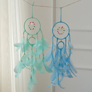 Handmade Indian dream catchers in mint green and blue with feathers and beads decoration