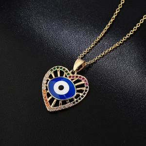 18K gold plated heart evil eye necklace with colorful zircons on black background