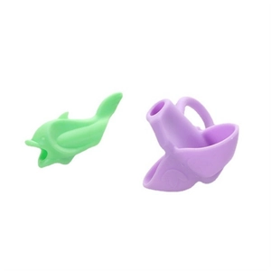 Close-up of ergonomic green dolphin and purple silicone pencil grips for kids