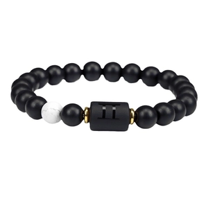 Gemini zodiac bracelet with black agate beads and white turquoise accent on white background