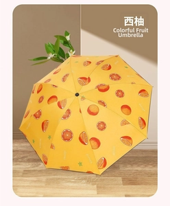 Detail of yellow grapefruit print umbrella with realistic fruit slices on wood floor