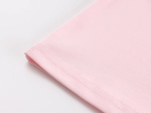 Close-up of pink sports tank top hem showing high-quality stitching and knit fabric