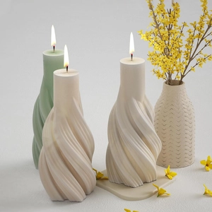 Spiral twisted pillar candles in cream and light green with elegant 3D ribbed texture