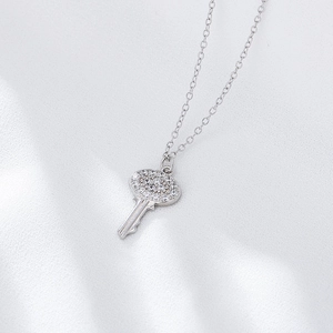 925 silver key necklace with sparkling zircon pavé setting on a white background