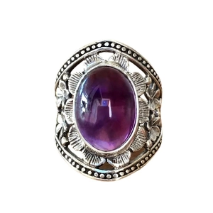 Vintage Bohemian ring with oval purple gemstone and engraved silver floral metal band