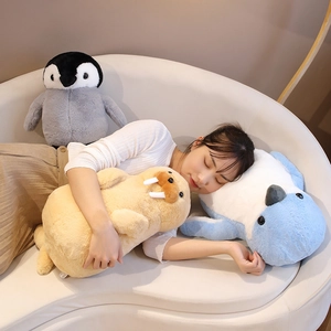 Soft plush penguin and sea lion stuffed animals used as sleep pillows for kids