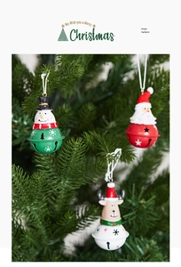 Close-up of Christmas iron bells featuring snowman, Santa, and reindeer on tree branches