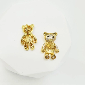 Detailed front and back view of a gold teddy bear pendant with crystal stone inlay