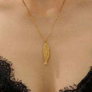 Close-up of gold fish pendant with scale texture on delicate box chain necklace