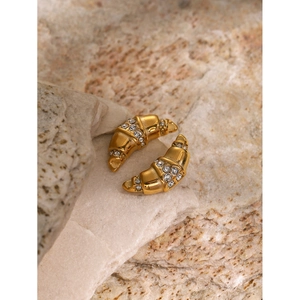 18k gold plated croissant earrings with white diamonds on natural stone surface