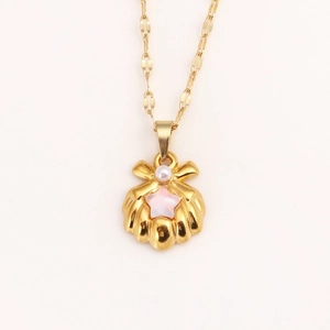Golden shell necklace with small pearl and pink star pendant on a flat link chain