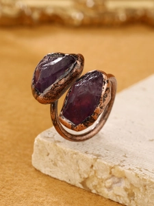 Close-up of vintage bronze adjustable ring featuring two raw purple amethyst stones