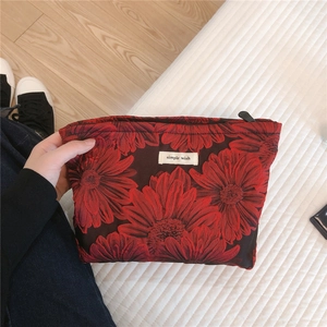 Detail of floral jacquard fabric on a cosmetic bag with Simple Wish label and zipper