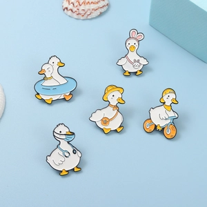 Set of five creative cartoon duck enamel pins with colorful summer accessories