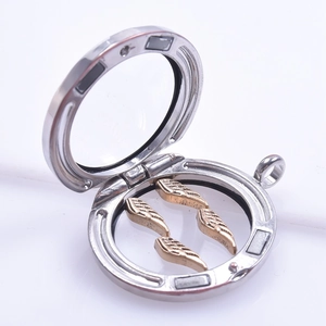 Silver floating locket detail showing open magnetic closure and golden feather charms