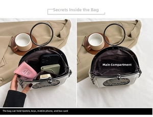 Detail view of spacious main compartment in silver shell bag with chic black round handle