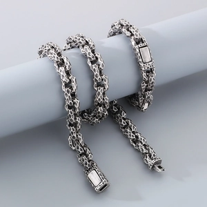Detail of vintage silver hammered texture bracelet on a grey pedestal with square buckle