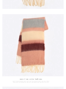 Detail of striped acrylic cashmere scarf with tassels in grey pink and burgundy colors