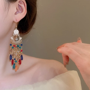 Detailed view of bohemian teardrop earrings with multi-color beads and long tassels