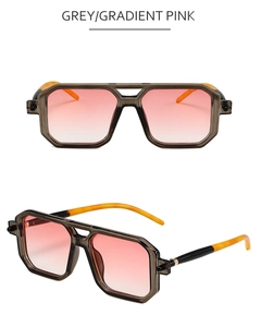 Detail view of square double bridge sunglasses with grey frames and pink gradient lenses