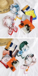 Detailed display of silk-like square scarves with colorful prints and elegant satin texture