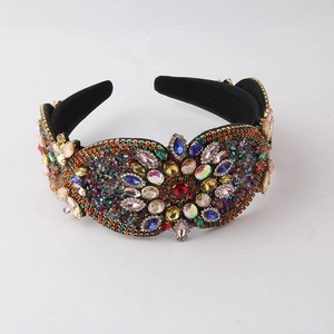 Detail of colorful rhinestones and crystal clusters on baroque wide padded headband