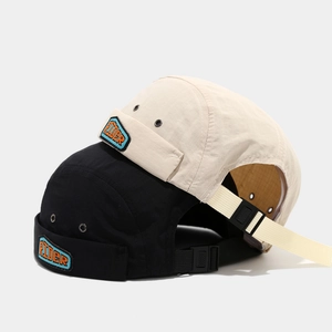 Retro ripstop Miki hats in beige and black featuring Rider patch and adjustable strap