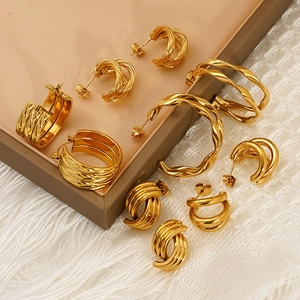 Double-layered C-shaped gold stainless steel hoop earrings with a twisted metal design