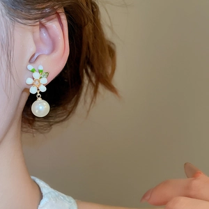 Nahaufnahme von 18k vergoldeten Blumenohrringen mit Perlenanhänger in der Seitenansicht