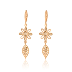 Close-up of gold-plated champagne floral earrings with white zircon leaf drops