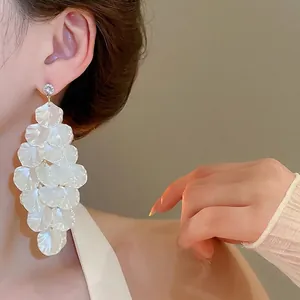 Elegant long leaf tassel earrings with white pearlescent shell petals and crystal studs