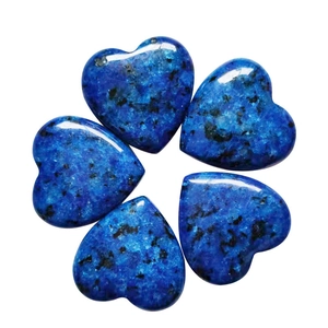 Set of five heart-shaped blue natural stones with black spots on a white background