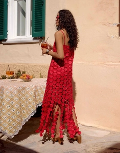 Detail of red French-style hollow dot dress with laser-cut texture and elegant tassel hem