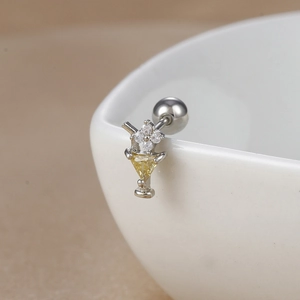 Macro shot of 18K gold-plated stainless steel cocktail glass stud earrings with yellow zircon