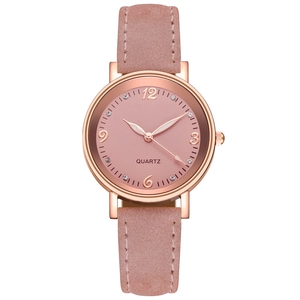 Detailed close-up of pink suede watch strap and rose gold dial with rhinestone indexes