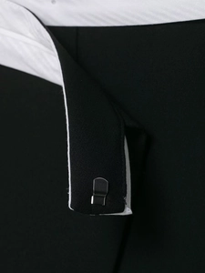 Macro shot of metal hook-and-bar closure on black skirt with white twill lining